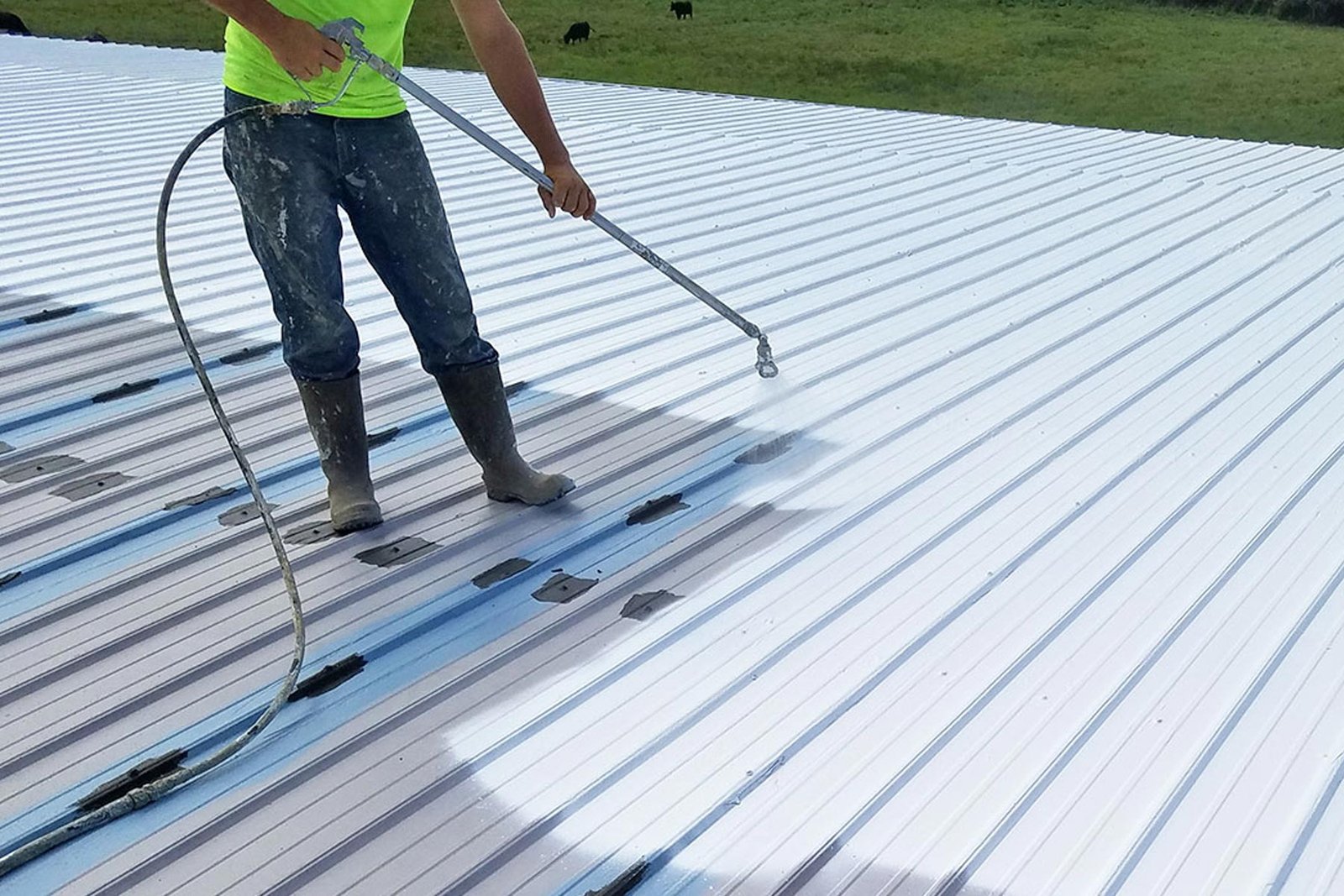 Homeguide contractor coating and sealing a metal roof jyd7zw